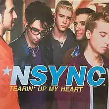 The NSYNC members are seen crowded near each other while facing different directions