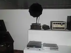A gramophone, vinyl player, and radio, all on display.