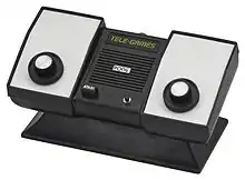 Photo of a dedicated video game console with two knobs.