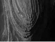 Layers in Terby crater, as seen by HiRISE. Layers may have formed when the Hellas basin was filled with water.