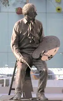 Statue of Terence Cuneo, Waterloo station, London.