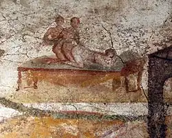 Sex between a female and two males. Wall painting. Suburban baths, Pompeii.