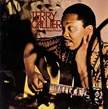 A photo of Callier seated with a guitar