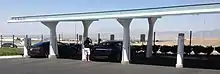 Tesla supercharger rapid charging station, California. The stationary solar arrays are on top]