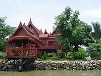 Traditional Thai-style stilt house on a canal near the Chao Phraya River in Bangkok.