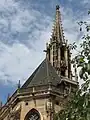 Detail of couloured tiled roof and of spire