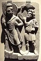 The Buddha with his protector Vajrapāni. Gandhara, 2nd century CE.