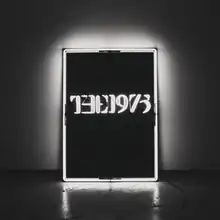 A black-and-white photo showcasing a rectangular, glowing neon sign against a wall in the near-center saying "The 1975".