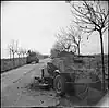 Sherman tanks passing a disabled German armoured car