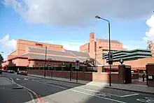A photograph of the British Library showing a blue sky and red bricks.