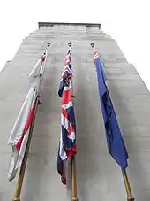 Fabric flags on the side of a stone monument