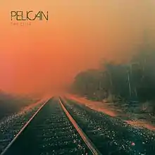 An orange-tinted photograph of a railroad