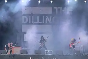 The Dillinger Escape Plan at With Full Force 2014. From left to right: Greg Puciato, Billy Rymer behind Liam Wilson, and James Love.