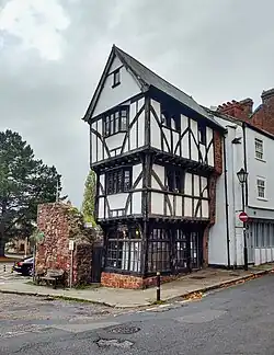 Front three quarters image of The House That Moved, showing its position on the corner, and clearly showing the half-timbered overhanging construction