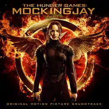 Cover art features Jennifer Lawrence in a black bodysuit with the wings from the film's logo behind Lawrence. The first part of the title appears at the top of the cover art while the second appears at the bottom.