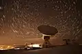 The IRAM 30-meter telescope scanning the night sky.