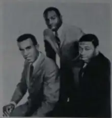 The three musicians wearing suits
