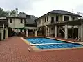 In 2011 before repairs to the roof. View from the back, showing the pool and BBQ area.