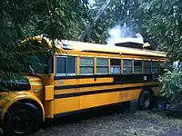 A yellow school bus being used as a residence