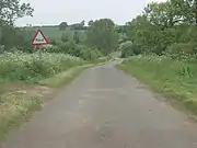 The road crosses a ford just north of Graby.  This is an idylic view of the Lincolnshire countryside with the hedgerows and trees in full summer splendour and the Keck in bloom along the road verges.