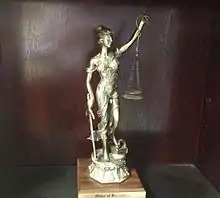 An image of a trophy awarded to a new member of the Order of Barristers.  The trophy consists of a statute of Lady Justice.