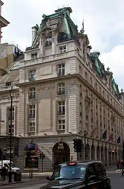 Side view of the Ritz hotel, Piccadilly, including a neon sign above an entrance