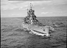 Black-and-white photograph of a battleship at sea