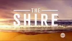 The Shire Text spread across a beach