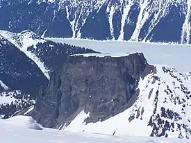 Flat-topped, steep-sided mountain rising above the surrounding mountainous landscape.