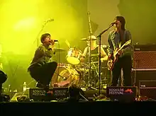 The Tears performing at Roskilde Festival in Denmark in 2005. From left to right: Brett Anderson, Makoto Sakamoto (behind the drums), Bernard Butler. Will Foster and Nathan Fisher out of sight.