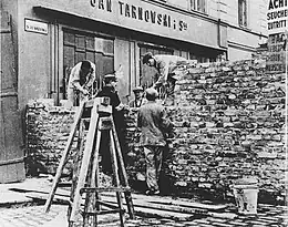The wall of the Warsaw Ghetto being built under the orders of Dr. Ludwig