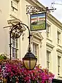 Scrolled iron lamp and sign brackets mentioned by Historic England