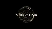The logo shows the words "The Wheel of Time" on top of a coiled silver snake