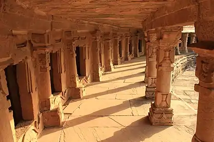 Circular walkway with shrines that once held Yogini images, now filled with Shiva Linga images