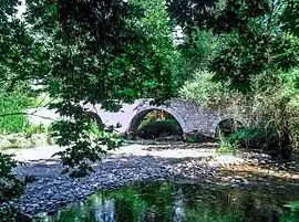 The three arches stone bridge of Paos River near Dafni
