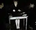 Magicians Julien Proskauer (left) and Hardeen (right) revealing a fraudulent method of table-turning. Both wore wrist bands with metal hooks to lift the séance table.