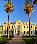 The original Drostdy was the first public building in Stellenbosch and was a U-shaped building which was completely rebuilt, in 1763. It was then given an H-shape and the front of a traditional Cape Dutch farmhouse. It served as Drostdy until 1827. In 1859 the building was donated to the D.R. Church and the Theological Seminary was opened there. The building forms an integral part of the historic character of Dorp Street as well as of the historic core of Stellenbosch.