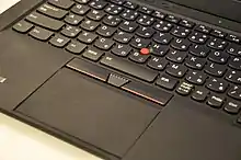 Photograph of the ThinkPad X1 Carbon's Japanese keyboard, track point, and trackpad