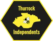 A hexagon with a map of Thurrock inside it. Inside the map is a picture of a bee.