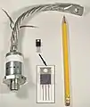 A low current thyristor and a high power device, with a threaded stud for attachment to a heat sink, and a flexible lead; such packages are used for devices rated for hundreds of amperes.