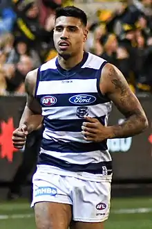 Male athlete jogging during an Australian rules football game