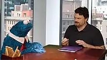Double Fine founder Tim Schafer (right) and Cookie Monster (left) during a promotional video for Sesame Street: Once Upon a Monster