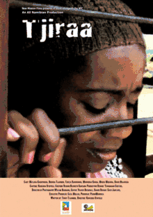 The film's poster; A young Black woman with a brown knit hat, holding onto the bar of a metal barrier of some sort with her right hand, and leaning her head on the bar. She is crying.