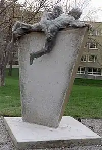 The annual obstacle course race at Royal Military College of Canada is memorialized by a sculpture by John Boxtel, To Overcome, which was a gift from the 1991 graduating class