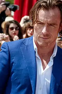 Toby Stephens in a blue jacket