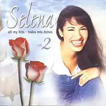 Album artwork of All My Hits: Todos Mis Éxitos Vol. 2 featuring a picture of Selena smiling and two red roses nearer to the left.