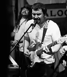 Black Camaro's Tom Miller (center) and Jimi "Fuzz" Berg (left) performing live