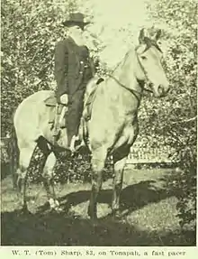 Black and white photo of Sharp on a standing horse. At the bottom, text reads "W. T. (Tom) Sharp, 82, on Tonapah, a fast pacer".