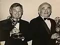 Ed Asner presents the 1990 Emmy for outstanding television documentary series, "Planet Earth" to Tom Skinner.