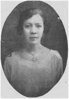 black and white photograph of the upper torso of a woman in a scoop-necked dress